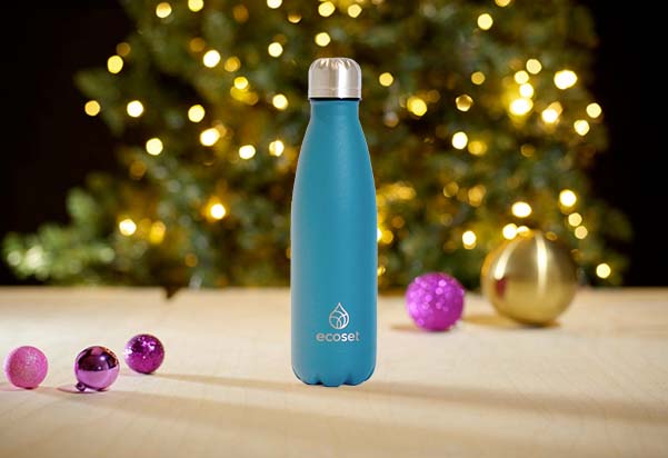 A blue Ecoset stainless steel water bottle standing beside Christmas tree baubles