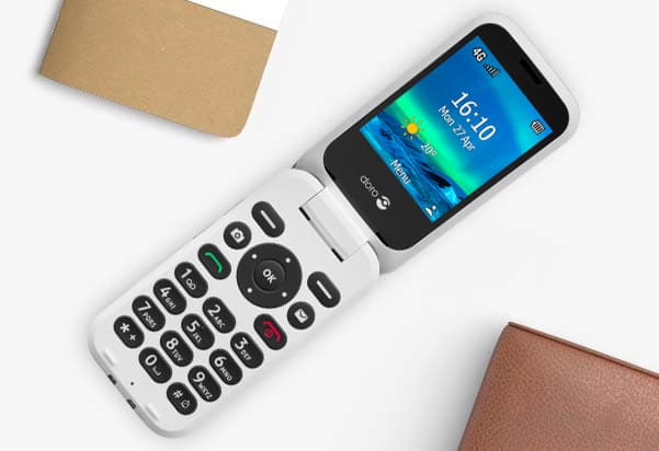 An open white flip phone with a black screen is displayed on a white surface. An open white flip phone with a black screen is displayed on a white surface.