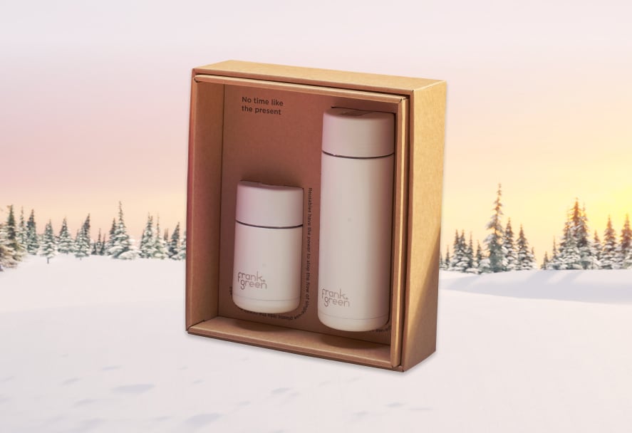 Frank Green reusable cups in a gift box set on a snowy mountain backdrop
