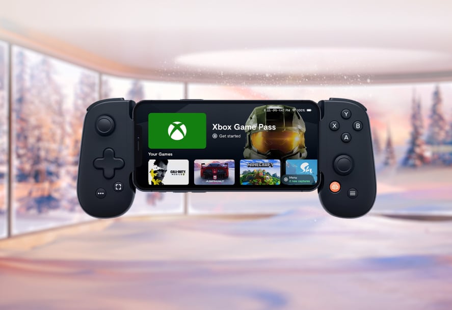 A black backbone one game controller that's displaying games on the screen 