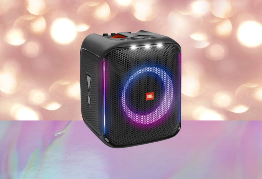 A black JBL Partybox Encore speaker with LED lights on a sparkle backdrop
