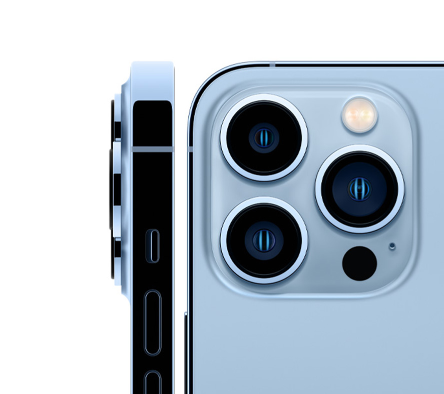 A close-up of the iPhone 13 Pro's triple camera system in Sierra Blue, showcasing the wide, ultra-wide, and telephoto lenses with LiDAR scanner
