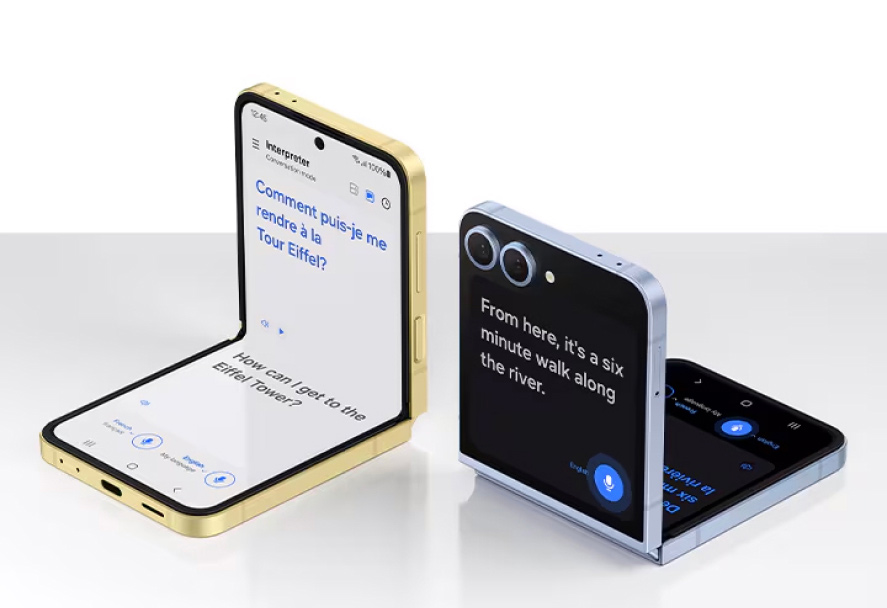 Two Samsung Galaxy Z Flip phones are shown in a partially folded, upright position, showing Interpreter & Live Translate. Two Samsung Galaxy Z Flip phones are shown in a partially folded, upright position, showing Interpreter & Live Translate.