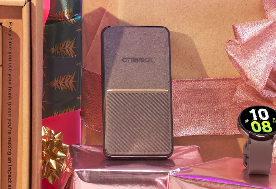 Black Otterbox portable charge leaning against a wrapped gift