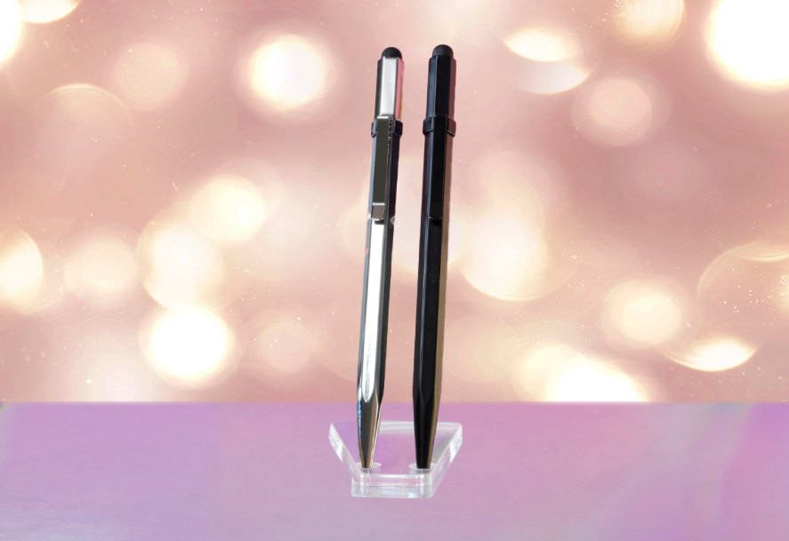 A black and silver Lexon Bee 2 Pens with a sparkly backdrop