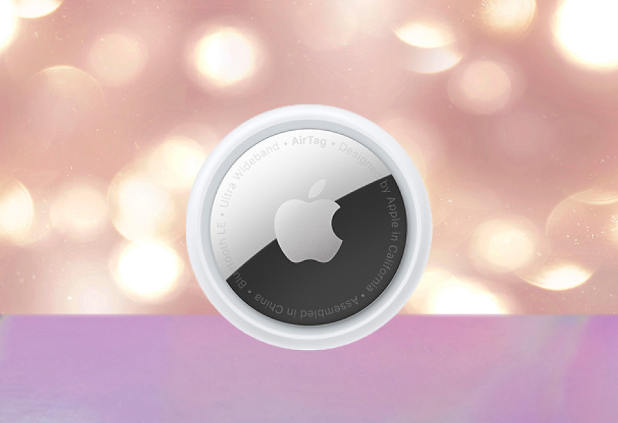 A white Apple AirTag on a sparkly backdrop