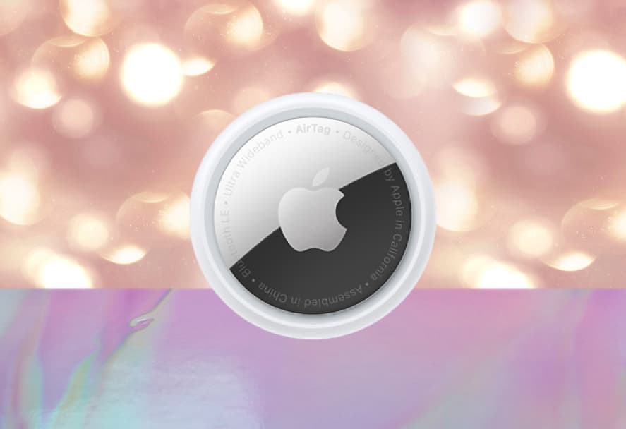 A white Apple AirTag on a sparkly backdrop