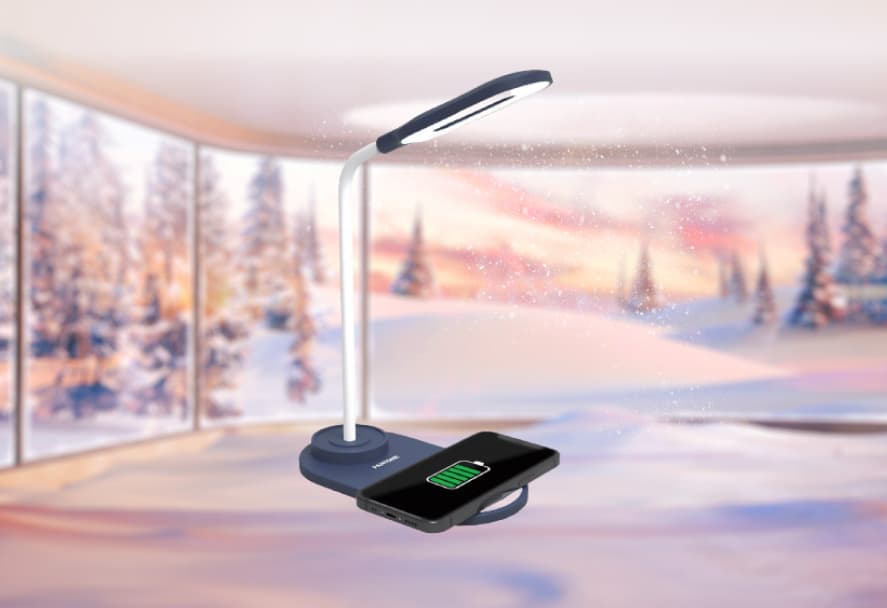 A white desk light with an attached wireless charger on a festive backdrop