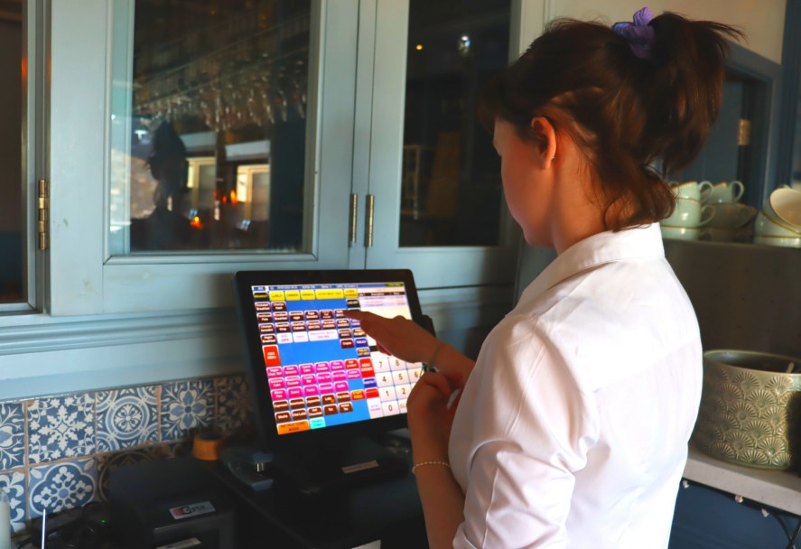 A waitress using the electronic cash register at Gourmet Food Parlour