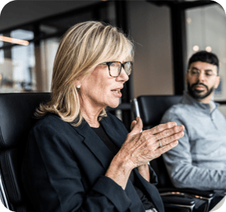 Two people having a discussion in a meeting room. Two people having a discussion in a meeting room.