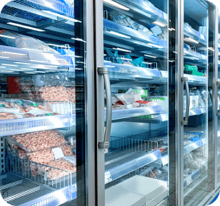 Refrigeration unit in a supermarket setting containing various packages of frozen food. Refrigeration unit in a supermarket setting containing various packages of frozen food.