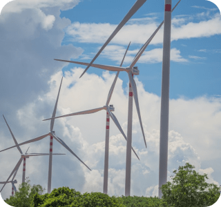 Wind turbines against a backdrop of clouds in a clear blue sky, symbolizing renewable energy and sustainability. Wind turbines against a backdrop of clouds in a clear blue sky, symbolizing renewable energy and sustainability.