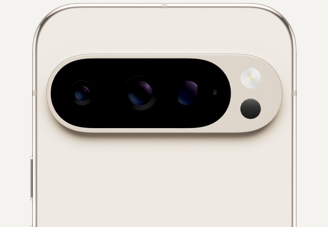  A close-up shot of the top back of a beige smartphone, highlighting its horizontal camera bar with three lenses and a flash.
