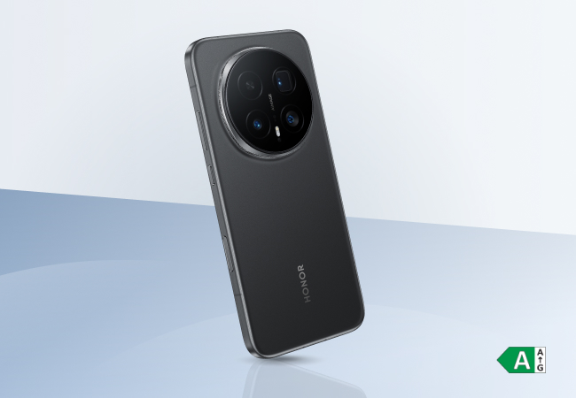 Back of a matte black HONOR smartphone showing its signature large circular quad-camera array and sleek metallic frame.