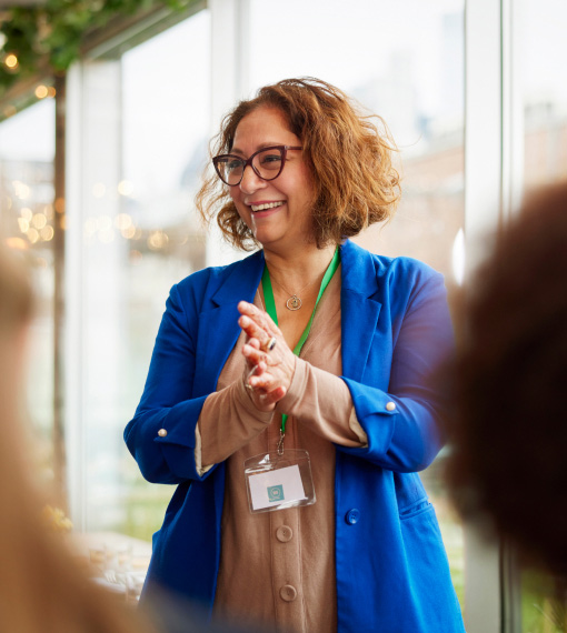 Person wearing a lanyard speaking in a group