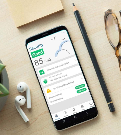 Smartphone face up on a desk, showing security information, placed beside ear pods, a pencil and pair of glasses.