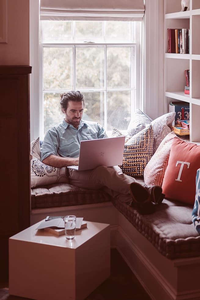 Man browsing internet using laptop on wifi