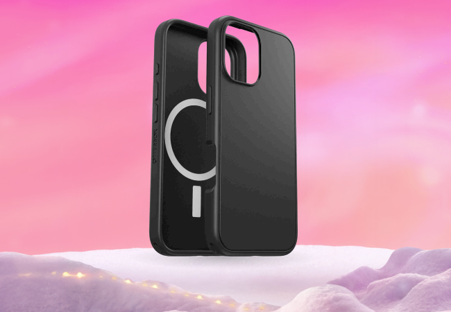 Two black smartphone cases standing upright on a snowy pink platform, one showing the exterior and the other showing the interior with a white magnetic charging ring.