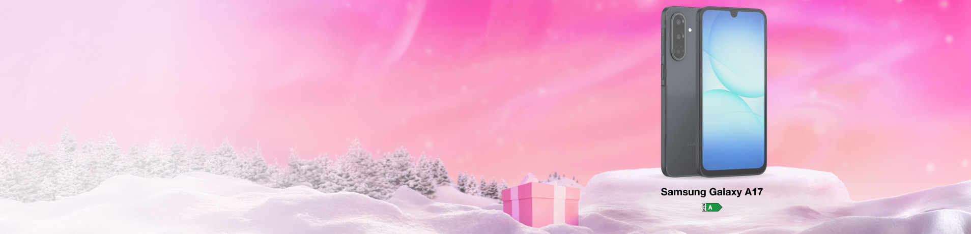 Panoramic winter banner with a Samsung Galaxy A17 on a snowy mound next to a gift box under a bright pink sky.