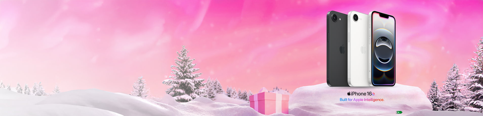Four iPhone 16e phones in different colors standing upright on a snowy landscape with pink wrapped gifts, Christmas trees, and a pink sky. Text reads "iPhone 16e Built for Apple Intelligence."