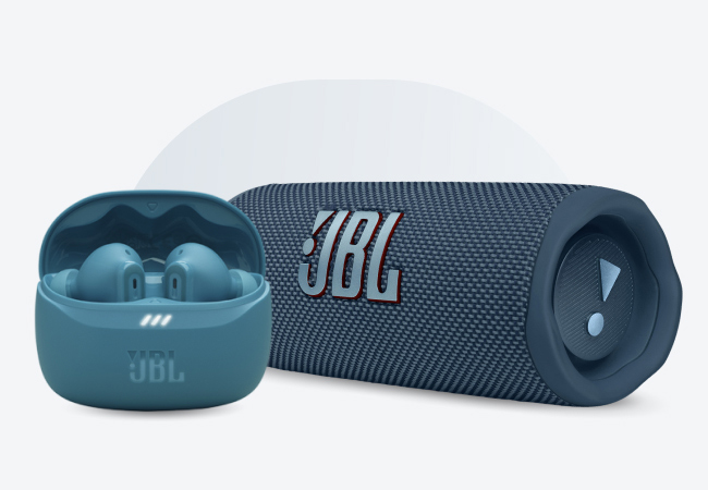 Blue JBL earbuds in charging case next to matching portable speaker.