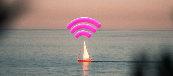 A sailboat floats on calm water at sunset. Large pink wifi signal graphics show above the boat, appearing as if the boat is broadcasting a wireless signal. The sky is a soft pink and orange colour,blending into the blue of the ocean.