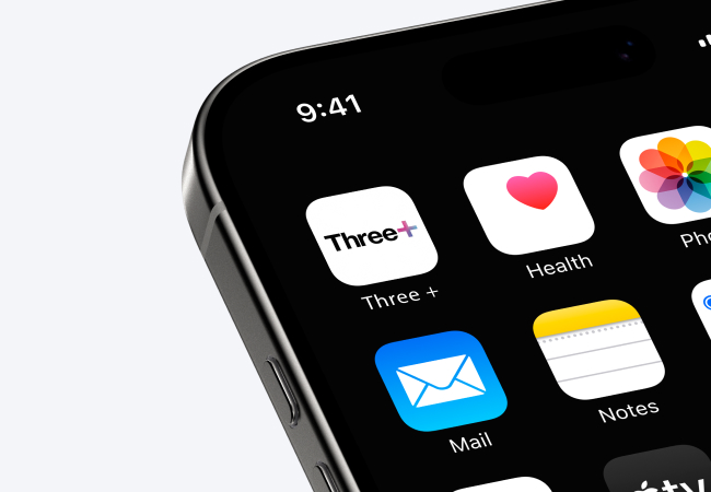 A close-up of a modern smartphone screen shows a row of apps against a dark background. The apps visible are Three+, Health, Mail, and Notes. The time on the phone's status bar is 9:41.