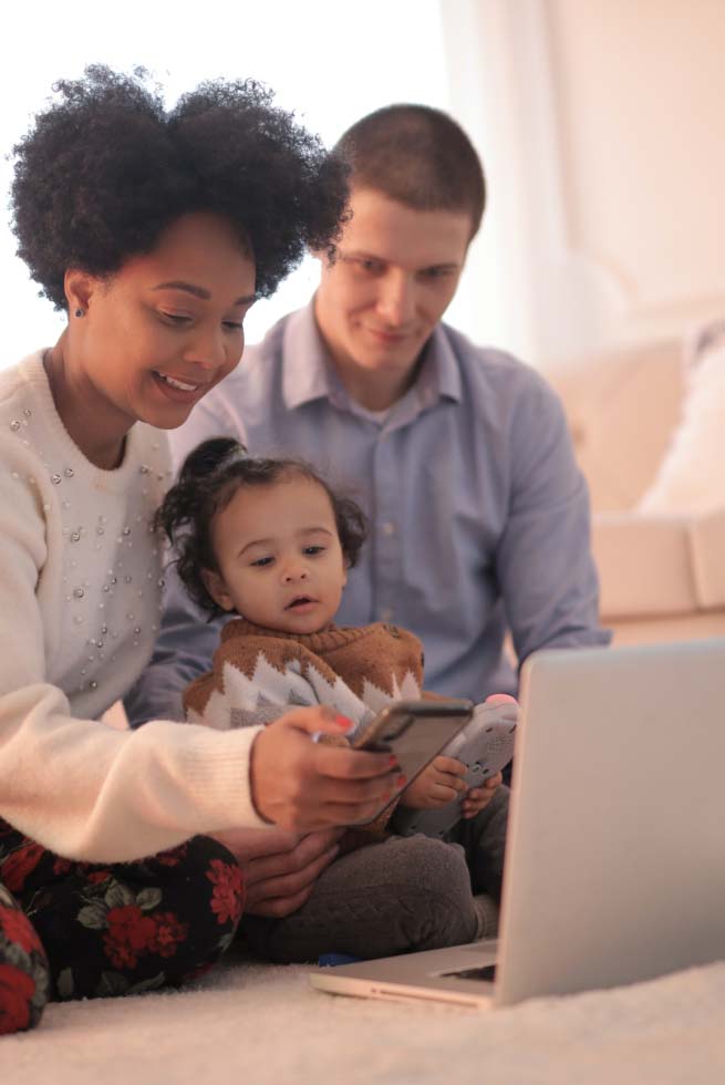 A family using multiple phones and laptops.