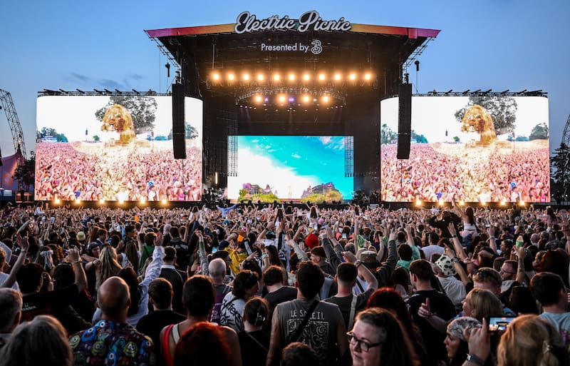 A large outdoor concert stage at Electric Picnic filled with a massive crowd of cheering festivalgoers in front of giant screen displays.