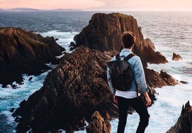 A man getting 5G in a remote coastal part of Ireland.