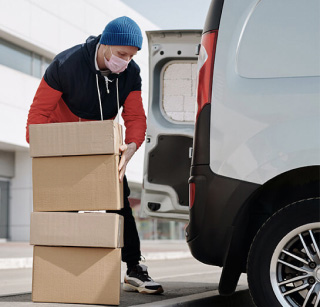 A man loading a D.I.D Electrical delivery van. A man loading a D.I.D Electrical delivery van.